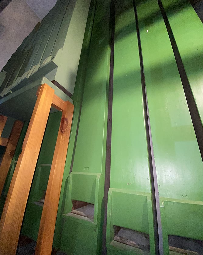 The largest pipes are wooden and housed at the back of the chamber