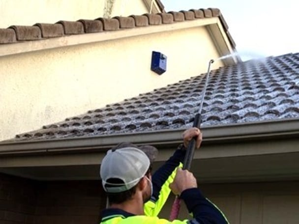 roof moss treatment being applied