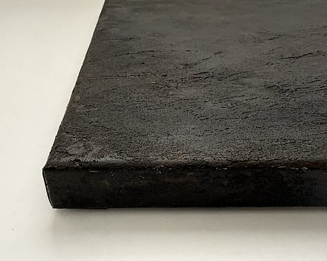 side view of canvas showing deep cocoa-toned granular surface, raised texture and canvas depth
