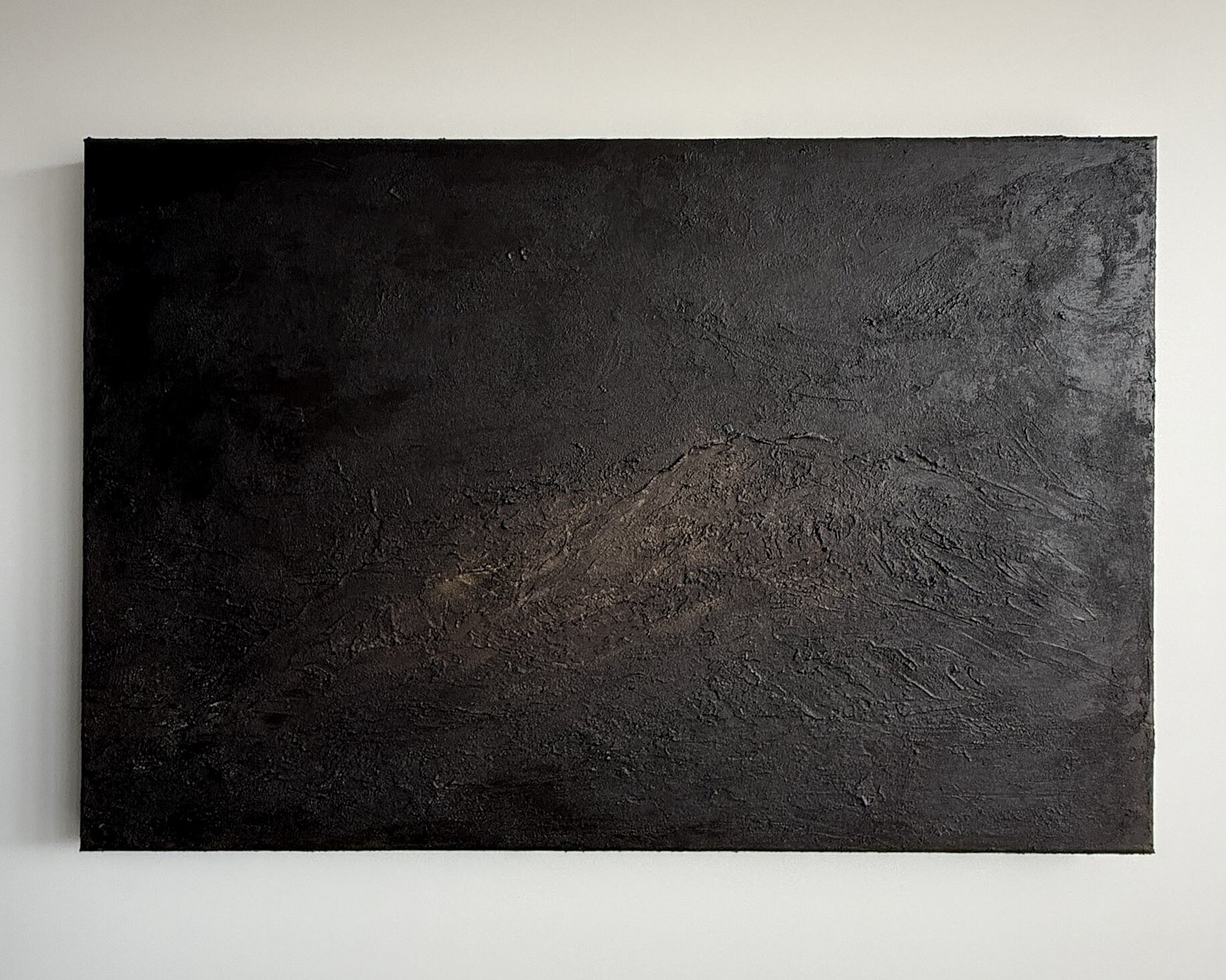 full image of atmospheric landscape painting on linen, with a heavily textured deep cocoa-toned mineral surface creating fractured ridges and recessed pockets with soft caramel tones blended along the central ridge