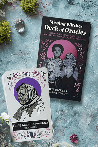 Missing witches deck of Oracles Oracle Deck pictured on a moss and gem background with one card showing - Emily Kame Kngwarreye - Dreaming to show what the deck looks like.