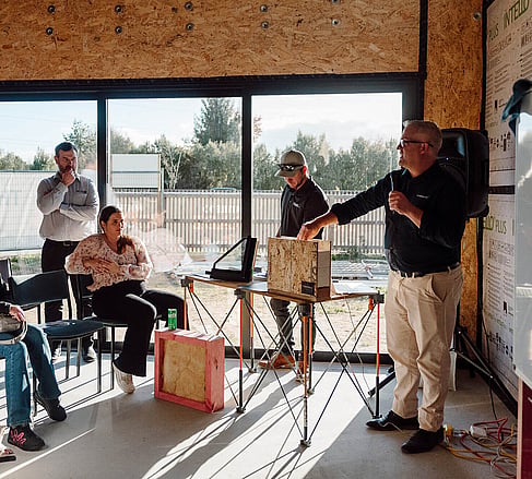 Ebode team presenting to guests inside a mid-build high-performance home