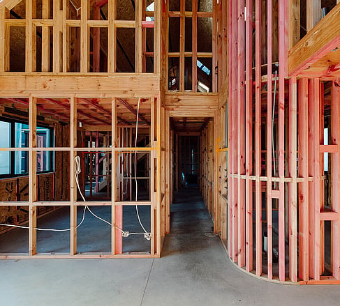 Inside an Ebode mid-build home showing exposed wooden framing and SIP construction