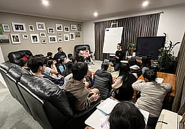 Image of ESOL students facing an English language teacher