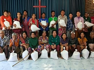 Cambodian people receiving gifts of rice