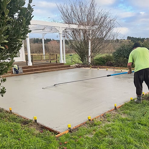 Concrete layer finishing concrete patio poured by Crewmix CM1000 machine