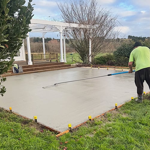 Concrete layer finishing concrete patio poured by Crewmix CM1000 machine