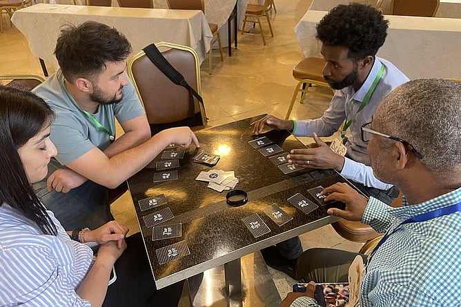 Children’s worker Bereket Berehanu demonstrates how to play a card game, of his own design, that explains the gospel to kids.