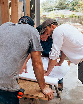 NZ tradies on site discussing job admin, quotes, and scheduling