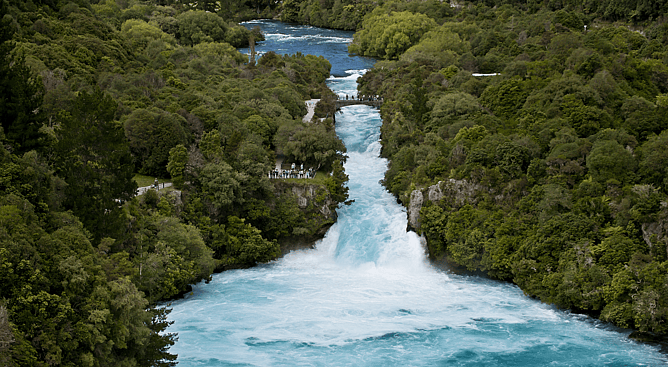 Aerial view of roaring blue water flowing through Huka Falls near Taupo New Zealand