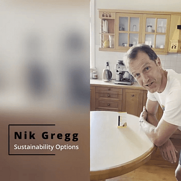 Man leaning on dining table in kitchen with a thermometer next to him