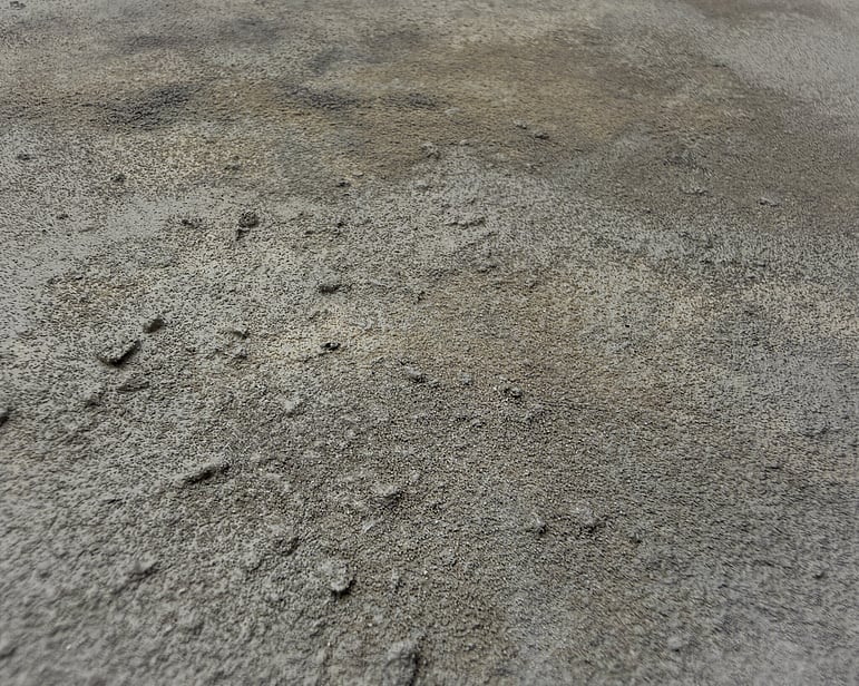 detail image showing irregular clusters of pumice texture, subtle raised surface, softly blended mineral and stone tones, smooth recessed areas and densely textured patches