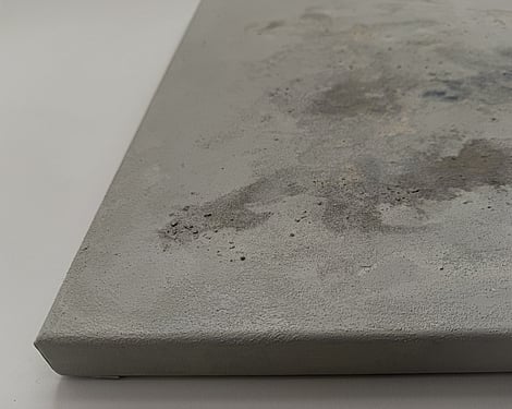 side view of canvas showing raised pumice texture, smooth recessed areas, layered mineral and stone tones and canvas depth