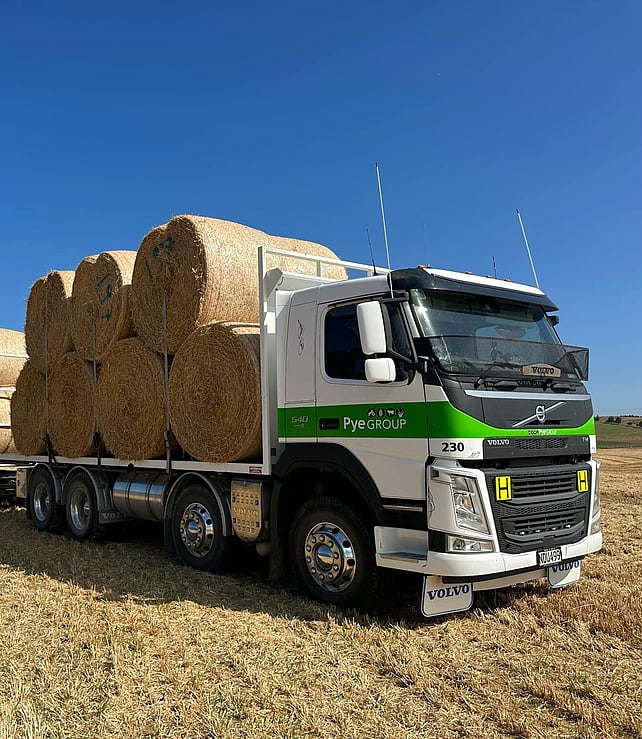 A Pye Group truck carting round bales across a Canterbury farm