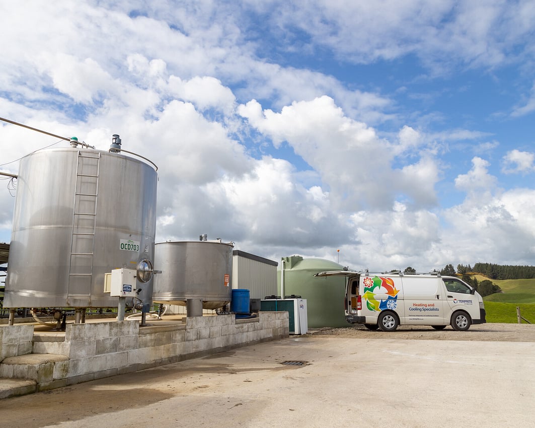 Milk vats on a dairy farm with a Temprite van parked nearby