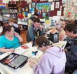 several people actively working at the table