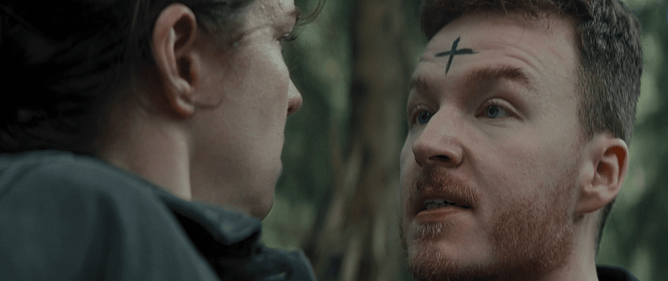 Ryan Ralph Gerrard carrying Darcey Wood through the Forest of Dean in the British supernatural thriller 'BINDING EVA'