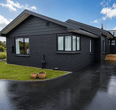Modernised black brick and weatherboard exterior after professional repaint in Rotorua