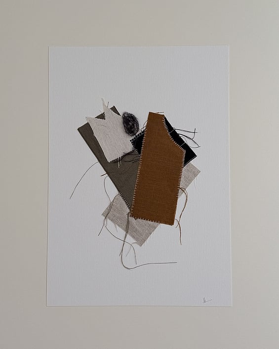 full image of a layered collage of earth-toned linen and cotton fragments on ivory fabriano, showing soft frayed edges, hand-stitched details, a swirl of charcoal baby alpaca/silk blend yarn and handwritten signature in lower right corner