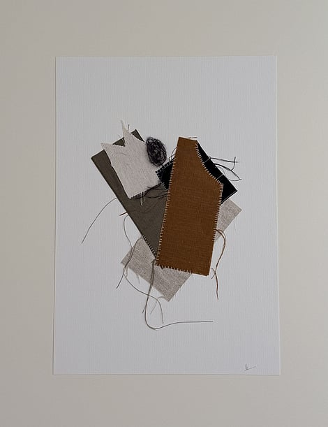 full image of a layered collage of earth-toned linen and cotton fragments on ivory fabriano, showing soft frayed edges, hand-stitched details, a swirl of charcoal baby alpaca/silk blend yarn and handwritten signature in lower right corner