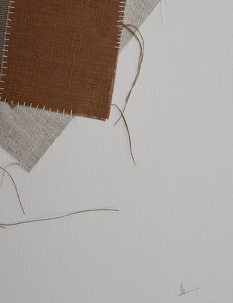 close-up image of ivory fabriano surface texture, layered cotton fragments with soft frayed edges and handwritten signature in lower right corner
