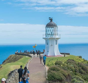 Cape Reinga, officially Cape Reinga / Te Rerenga Wairua, is the northwestern most tip of the Aupōuri Peninsula, at the northern end of the North Island of New Zealand. Cape Reinga is more than 100 km north of the nearest small town of Kaitaia. In Māori, Te Rerenga Wairua means the leaping-off place of spirits.