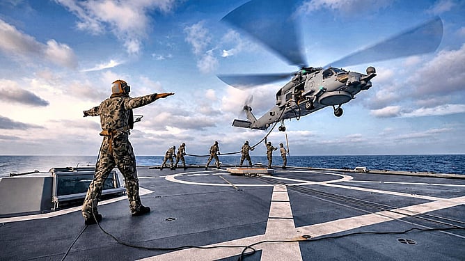 Royal Australian Navy helicopter operations on a ship's flight deck, representing TPM's work in the defence sector