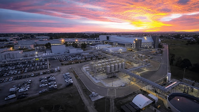 Aerial view of the CSL Behring Aurora plasma fractionation facility in Broadmeadows at dusk, showing process tanks and site infrastructure