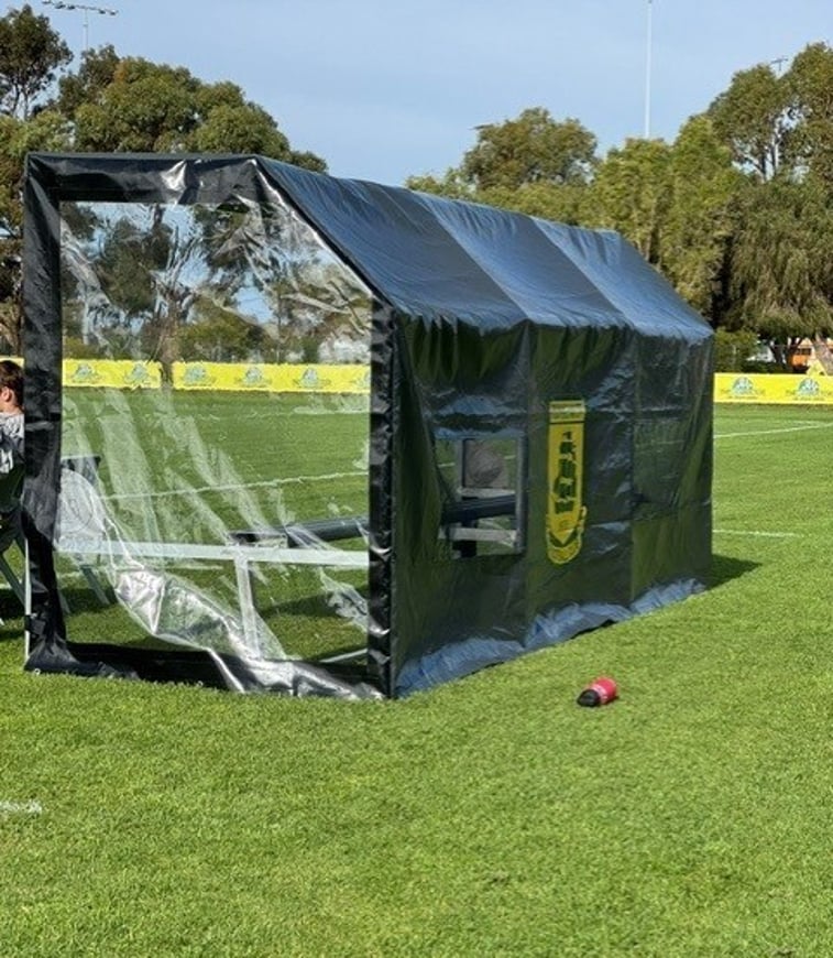 Custom all-weather dugout cover installed pitch-side at local sporting field