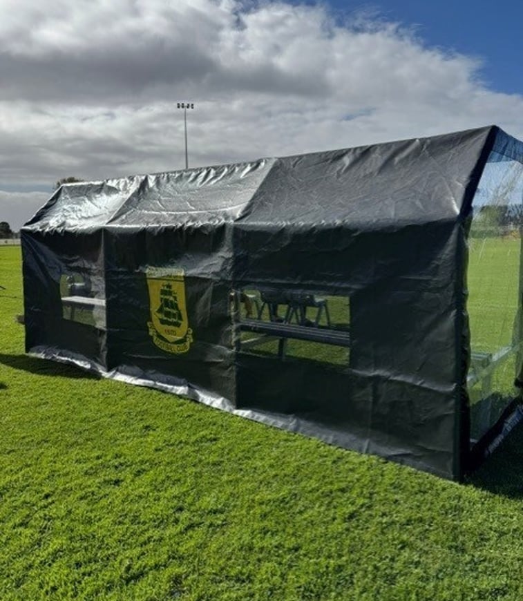 Dugout cover with side panel and mesh airflow section open, fitted to metal frame
