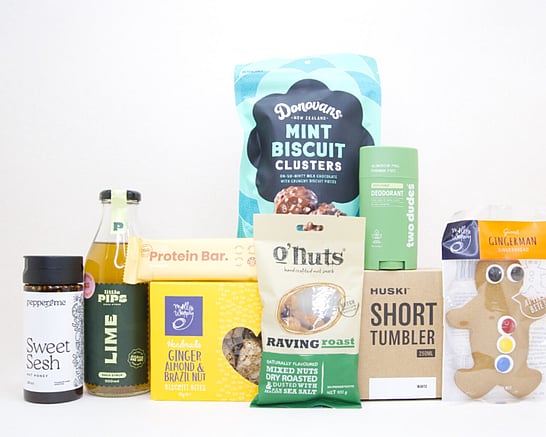 Gift box for men featuring gourmet nuts, a Huski tumbler, Little Pips treats, Sweet Sesh snacks, a protein bar and Donovan's mint chocolates