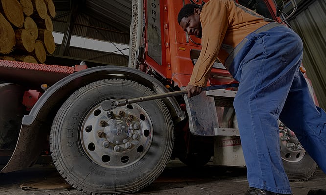 Image of diesel mechanic servicing tyres on a logging truck. Dudleys Mechanical & Parts. Taupo
