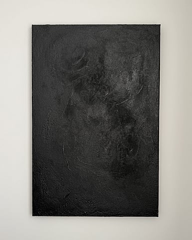 full image of atmospheric landscape painting on linen with a densely textured warm black surface created with acrylic, micaceous iron oxide and silica sand, showing irregular darker matte granular forms concentrated through the upper centre and right side, subtle shifts between matte and softly reflective areas and scattered raised ridges and fissures across the surface 