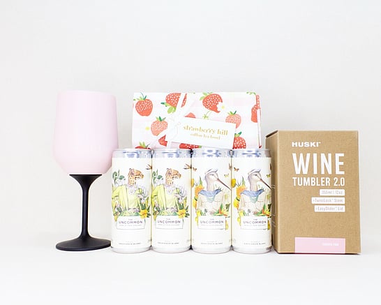 Gift box featuring four Uncommon wine cans, a Huski wine cooler and a New Zealand designed tea towel.