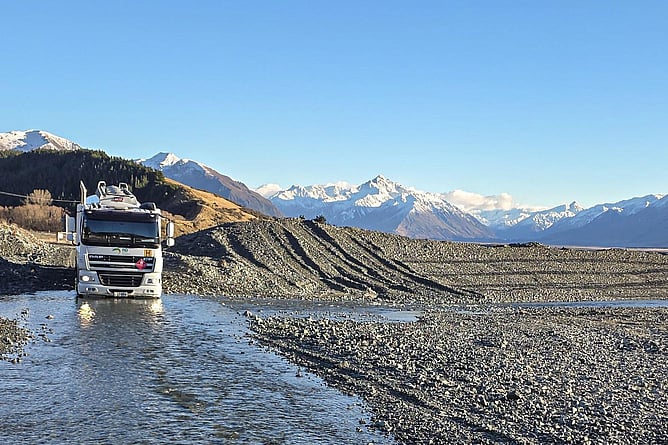 RD Petroleum fuel tanker crossing a shallow riverbed near Rakaia Gorge with the Southern Alps in the background