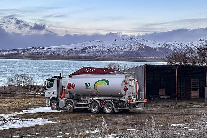 RD Petroleum fuel tanker parked beside a shed at Round Hill, Lake Tekapo, with mountains in the background