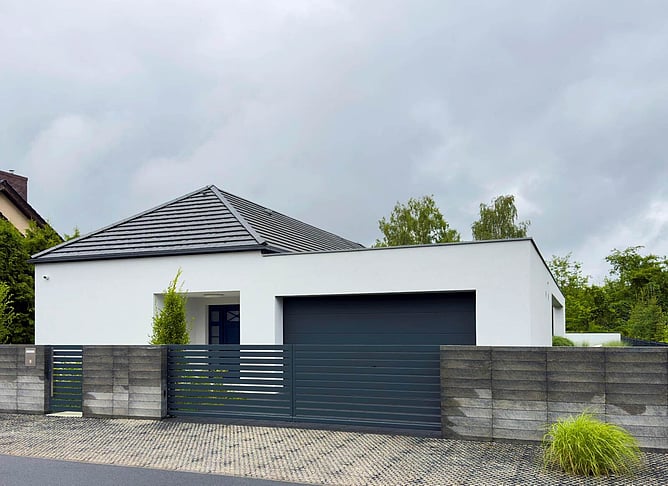 house with exterior upgrades for spouting and fencing
