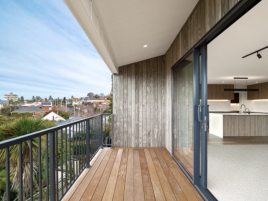 Decking with outdoor views of Highgate Ridge townhouses in Maori Hill. Built by MJW Homes. Dunedin, Otago.