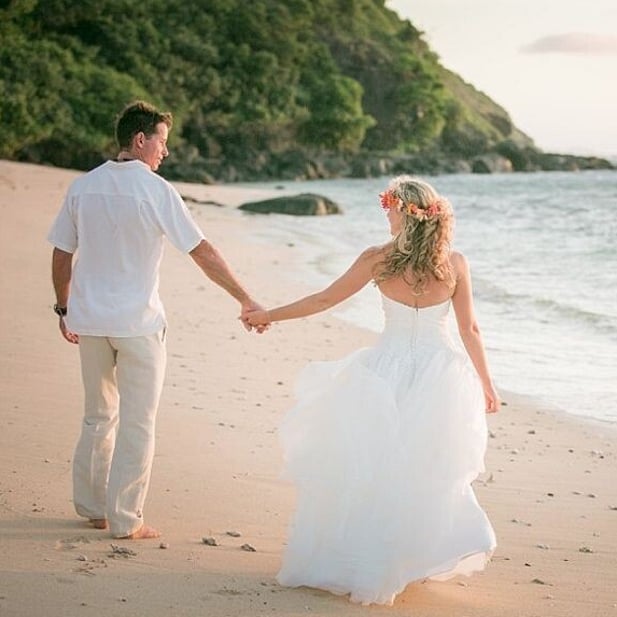 Paradise Cove Resort Fiji - Bride and groom strolling along the beach