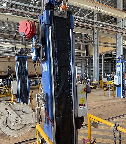 Tall custom PVC protective cover fitted to ore carriage jack, workshop setting