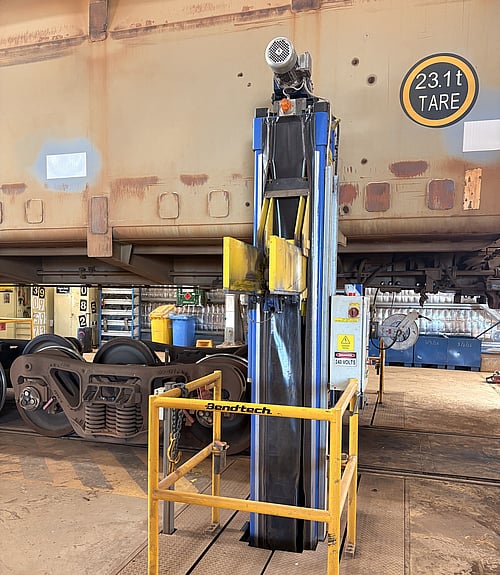 Tall custom PVC protective cover fitted to ore carriage jack, workshop setting