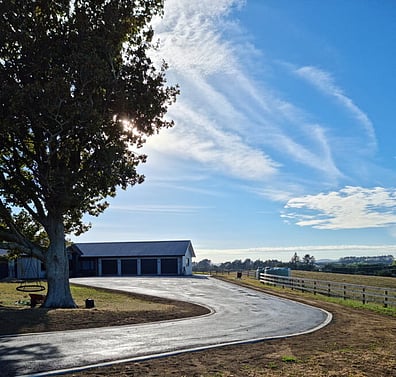 Finished reycled asphalt driveway with concrete curb