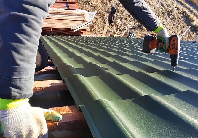 roofer attaching new roof replacement