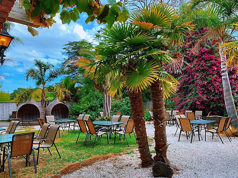 Outdoor garden dining at Game Keepers Restaurant in Waimauku