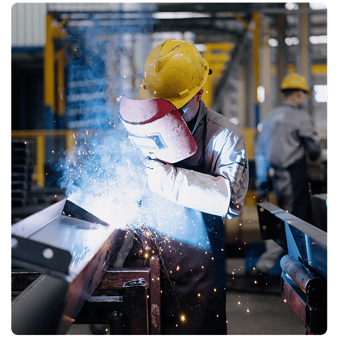 Welder working on a metal fabrication in a manufacturing workshop