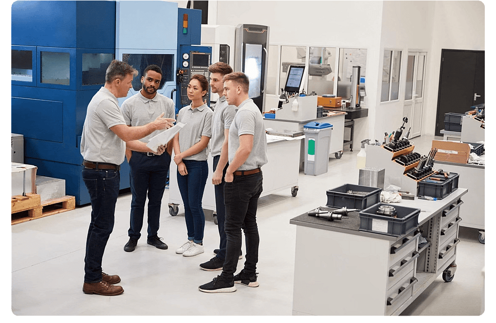 Team of colleagues talking in a manufacturing facility