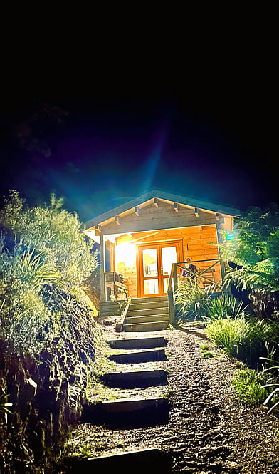 night-time exterior cabin at Tawa Cove