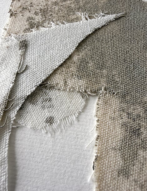 detail image of layered pale cream cotton fragments blotted with green-grey acrylic, showing weave texture and soft frayed edges