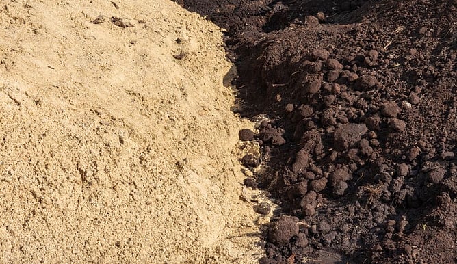 contrasting piles of soil types