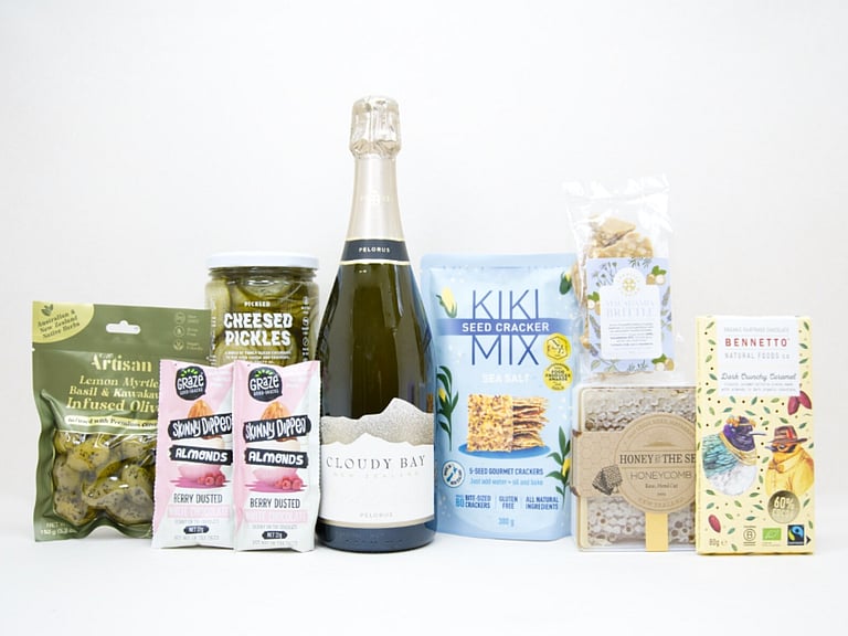 Congratulations Gift Box featuring Cloudy Bay Pelorus sparkling wine, artisan olives, pickled cucumbers, Kiki Seed Crackers, Sesh honey, Bennetto salted caramel chocolate, Skinny Dipped almonds, and macadamia brittle superseeds, beautifully packaged for celebrations and milestone gifting.